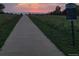 Peaceful walking trail at sunset, offering serene views and a connection with nature at 4501 Whitehall Ln, Highlands Ranch, CO 80126