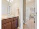 Bathroom featuring wooden cabinets, a vanity, and a tiled floor with an adjoining room at 13645 Osage Ct, Broomfield, CO 80023