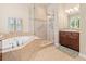 Elegant bathroom with a soaking tub, walk-in shower, and granite countertops at 13645 Osage Ct, Broomfield, CO 80023