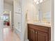 Bathroom featuring wooden cabinets, vanity, tiled floors, with a view of an adjoining room at 13645 Osage Ct, Broomfield, CO 80023