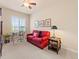 Neutral bedroom with window, a red sofa with decorative pillows, and side tables with lamps at 13645 Osage Ct, Broomfield, CO 80023