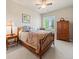 Bedroom featuring a ceiling fan, bed with decorative pillows, shuttered window, and decorative dresser at 13645 Osage Ct, Broomfield, CO 80023