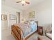 Comfortable bedroom with a wooden bed frame, ceiling fan, and natural light at 13645 Osage Ct, Broomfield, CO 80023