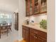 Elegant butler's pantry with custom cabinetry and granite countertops leading to dining area at 13645 Osage Ct, Broomfield, CO 80023