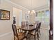 Elegant dining room with a chandelier and a view of the living room at 13645 Osage Ct, Broomfield, CO 80023
