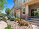 Attractive stone and siding home with a well-manicured front yard and flower pots at 13645 Osage Ct, Broomfield, CO 80023