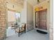 Inviting front porch with cozy seating, stone pillars, and a welcoming entrance at 13645 Osage Ct, Broomfield, CO 80023