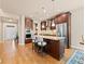 Well-appointed kitchen island featuring seating and stainless steel appliances, perfect for modern living at 13645 Osage Ct, Broomfield, CO 80023