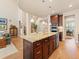 Open-concept kitchen with a large island, stainless steel appliances, and modern lighting fixtures at 13645 Osage Ct, Broomfield, CO 80023