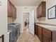 Laundry room with modern appliances, cabinetry, and tile flooring at 13645 Osage Ct, Broomfield, CO 80023