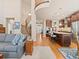 Open-concept living room and kitchen with a grand staircase and hardwood floors at 13645 Osage Ct, Broomfield, CO 80023