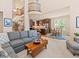 Bright living room with a fireplace, comfortable seating, and hardwood floors at 13645 Osage Ct, Broomfield, CO 80023