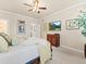 Well-lit main bedroom with neutral tones, ceiling fan, and an en-suite bathroom at 13645 Osage Ct, Broomfield, CO 80023