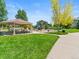 Community park featuring a picnic shelter, playground, and a spacious green lawn at 13645 Osage Ct, Broomfield, CO 80023