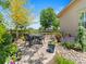 Cozy backyard patio with an outdoor dining set surrounded by lush landscaping at 13645 Osage Ct, Broomfield, CO 80023