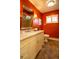 Bathroom featuring red walls, updated vanity, granite countertop, large mirror and tiled shower at 3098 S Vine St, Denver, CO 80210