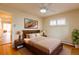 Comfortable bedroom with hardwood floors, ceiling fan, and bright natural light at 3098 S Vine St, Denver, CO 80210