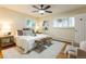 Bright bedroom featuring a ceiling fan, neutral walls, and white shutters for a serene and inviting atmosphere at 3098 S Vine St, Denver, CO 80210