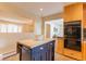 Well-appointed kitchen featuring an island with a butcher block top and modern appliances at 3098 S Vine St, Denver, CO 80210