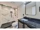 Stylish bathroom with a walk-in shower, black fixtures, and a marble-patterned vanity at 2865 S Yampa Way, Aurora, CO 80013