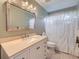 Bathroom vanity with a large mirror, single sink, and shower with curtain at 2865 S Yampa Way, Aurora, CO 80013
