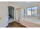Bathroom featuring a separate shower and soaking tub with a large window at 2865 S Yampa Way, Aurora, CO 80013