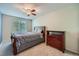 Bedroom featuring a full-sized bed, dark wood dresser, ceiling fan and window at 2865 S Yampa Way, Aurora, CO 80013