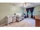Bedroom bedroom featuring a crib, changing table, ceiling fan and window at 2865 S Yampa Way, Aurora, CO 80013