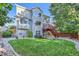 Charming two-story home with a well-manicured lawn, a deck, and mature trees at 2865 S Yampa Way, Aurora, CO 80013