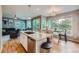 Open-concept kitchen with a large island, hardwood floors, and a view of the living room at 2865 S Yampa Way, Aurora, CO 80013