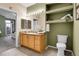 A well-lit primary bathroom with a granite-topped vanity, updated fixtures, and shelving at 457 Black Feather Loop # 703, Castle Rock, CO 80104