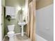 A traditional half-bathroom with tile flooring, a toilet, and a pedestal sink with decorative fixtures at 457 Black Feather Loop # 703, Castle Rock, CO 80104