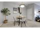 A bright dining area with a glass table and contemporary decor, illuminated by a pendant light at 457 Black Feather Loop # 703, Castle Rock, CO 80104