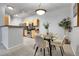 A cozy dining area with a glass table next to the open kitchen, perfect for modern living at 457 Black Feather Loop # 703, Castle Rock, CO 80104