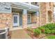 Charming home entrance featuring a well-lit porch and manicured landscaping at 457 Black Feather Loop # 703, Castle Rock, CO 80104