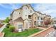 Attractive exterior view of a multi-story condo building featuring stone accents and well-maintained landscaping at 457 Black Feather Loop # 703, Castle Rock, CO 80104