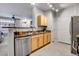 Functional kitchen layout with stainless steel appliances and views to the living area at 457 Black Feather Loop # 703, Castle Rock, CO 80104