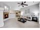A spacious living room with a fireplace, open to the dining area, creating an inviting atmosphere at 457 Black Feather Loop # 703, Castle Rock, CO 80104