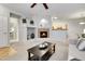 Open concept living area featuring a fireplace, views to the kitchen, and neutral carpeting at 457 Black Feather Loop # 703, Castle Rock, CO 80104