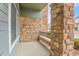 Cozy covered porch area with brick pillars providing a welcoming entrance to the home at 457 Black Feather Loop # 703, Castle Rock, CO 80104