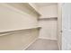 A well-organized walk-in closet with ample shelving for storage and organization, and neutral carpet at 457 Black Feather Loop # 703, Castle Rock, CO 80104