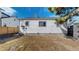 Small, sunlit backyard with a white house and fence visible at 4154 Depew St, Denver, CO 80212