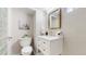 Modern bathroom featuring a white vanity, sleek fixtures, and a contemporary mirror at 4154 Depew St, Denver, CO 80212