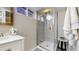 Contemporary bathroom boasts a glass-enclosed shower and elegant vanity with marble countertop at 4154 Depew St, Denver, CO 80212