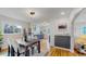 Bright dining area with hardwood floors, modern lighting and an adjacent kitchen at 4154 Depew St, Denver, CO 80212