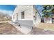 Side view of a light grey home with small windows and concrete stairs at 4154 Depew St, Denver, CO 80212