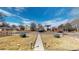 Well-maintained front yard featuring a concrete walkway and green bushes at 4154 Depew St, Denver, CO 80212