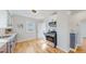 Well-lit kitchen featuring stainless steel appliances, white countertops, and hardwood floors at 4154 Depew St, Denver, CO 80212