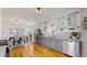 Bright kitchen with white cabinets, stainless steel appliances, and hardwood floors flowing into the dining area at 4154 Depew St, Denver, CO 80212