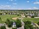 Aerial view of residential neighborhood next to a park with baseball field and walking paths at 885 Sage Sparrow Cir, Highlands Ranch, CO 80129